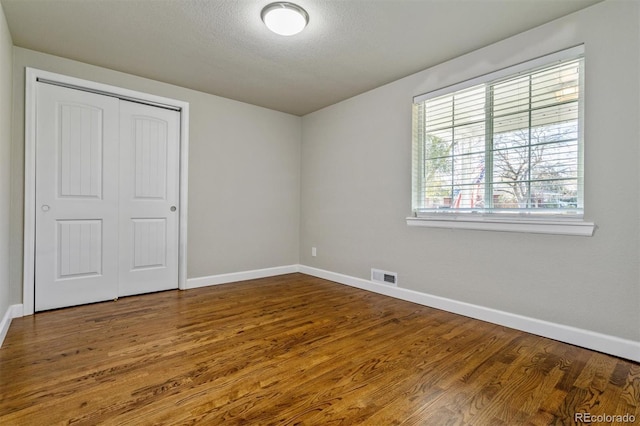 5500 Holland Dr, Arvada, CO 80002 - unfurnished bedroom featuring baseboards, wood finished floors, and a closet