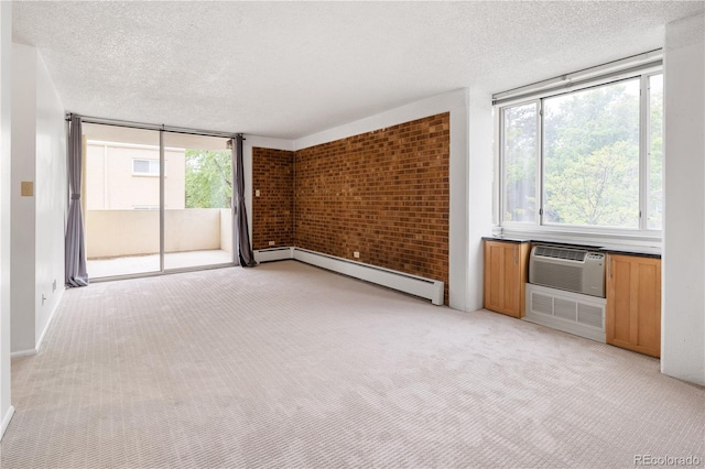 850 20th St Unit 201, Boulder, CO 80302 - unfurnished living room featuring baseboard heating, a textured ceiling, light colored carpet, healthy amount of natural light, and brick wall