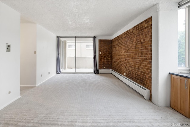 850 20th St Unit 201, Boulder, CO 80302 - unfurnished room featuring a baseboard radiator, light colored carpet, brick wall, a textured ceiling, and baseboards