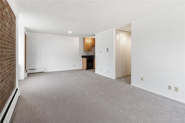 850 20th St Unit 201, Boulder, CO 80302 - spare room featuring baseboard heating, light carpet, a baseboard radiator, a textured ceiling, and brick wall