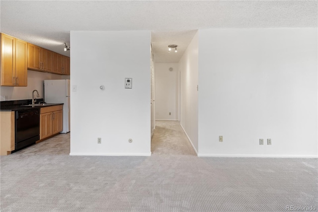 850 20th St Unit 201, Boulder, CO 80302 - kitchen featuring dishwasher, light carpet, freestanding refrigerator, a sink, and dark countertops