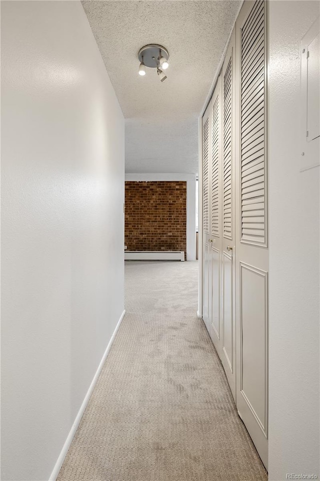 850 20th St Unit 201, Boulder, CO 80302 - corridor featuring carpet flooring, a baseboard heating unit, baseboards, brick wall, and a textured ceiling