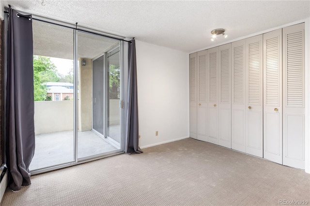 850 20th St Unit 201, Boulder, CO 80302 - unfurnished bedroom with access to exterior, carpet, and a textured ceiling