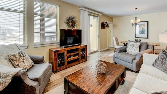 living room with a chandelier and light hardwood / wood-style flooring