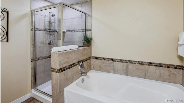 bathroom with separate shower and tub