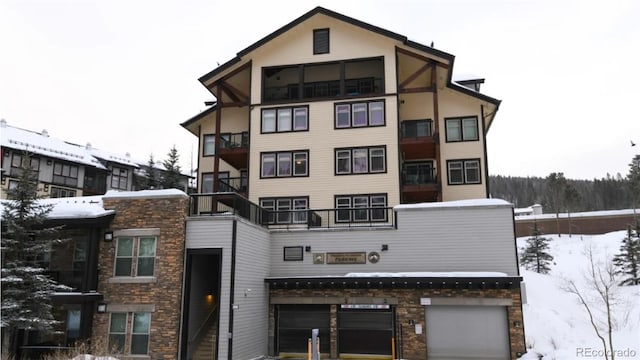 snow covered building with a garage