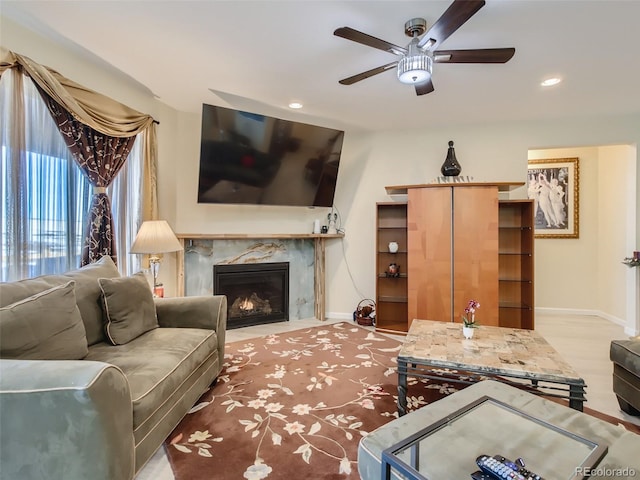 living room featuring ceiling fan, a fireplace, and hardwood / wood-style floors