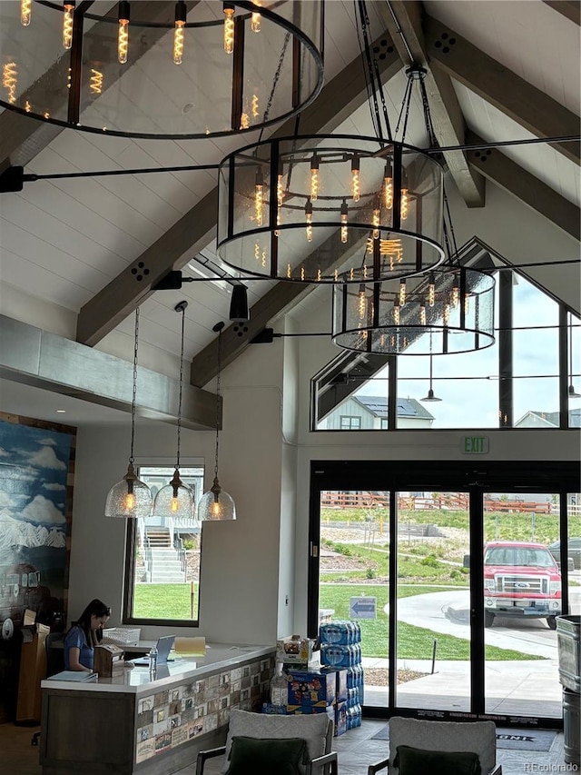 kitchen featuring beam ceiling, high vaulted ceiling, and a healthy amount of sunlight