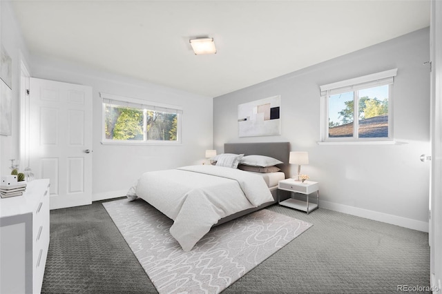 bedroom featuring dark colored carpet and multiple windows