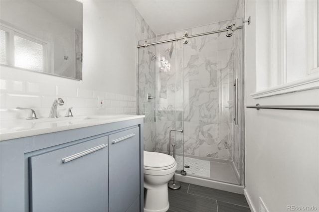 bathroom featuring vanity, toilet, and walk in shower