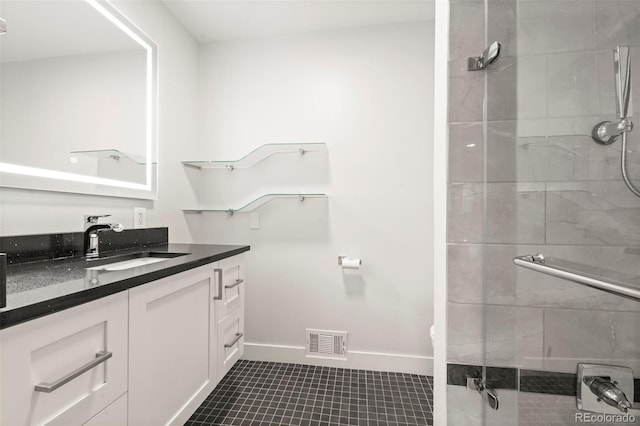 bathroom with vanity, tile patterned floors, and a shower with door