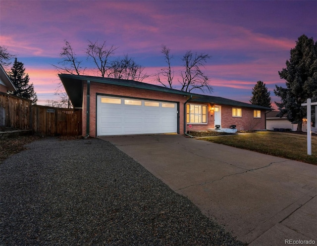 ranch-style house with a yard and a garage