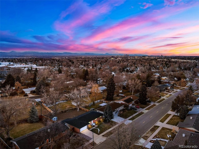 aerial view at dusk featuring a mountain view