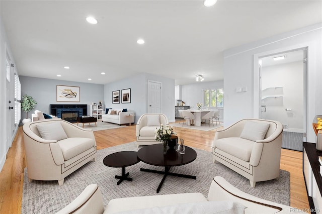 living room with light hardwood / wood-style floors and a tile fireplace