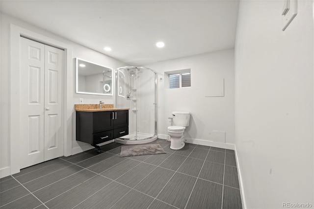 bathroom featuring walk in shower, tile patterned flooring, vanity, and toilet