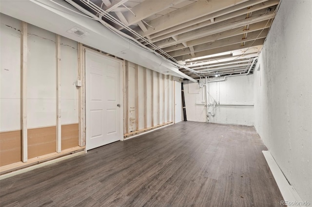 basement with hardwood / wood-style floors