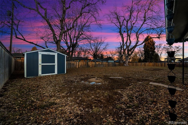 yard at dusk featuring a shed