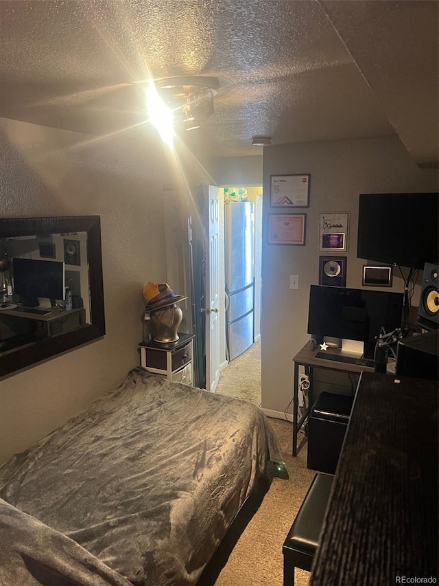 carpeted bedroom with a textured ceiling