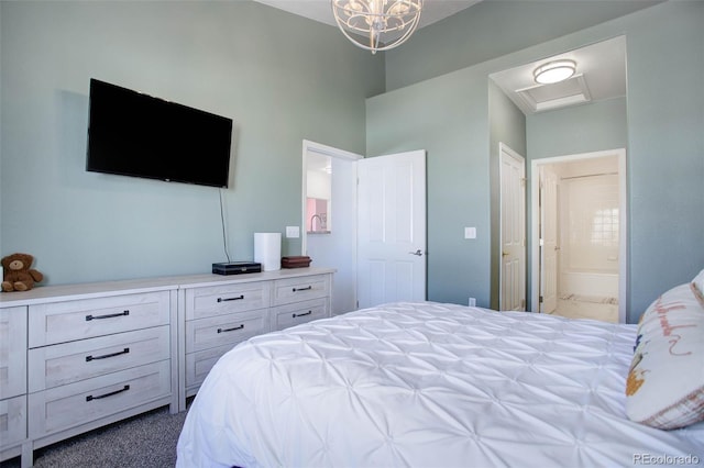 carpeted bedroom featuring a chandelier and connected bathroom