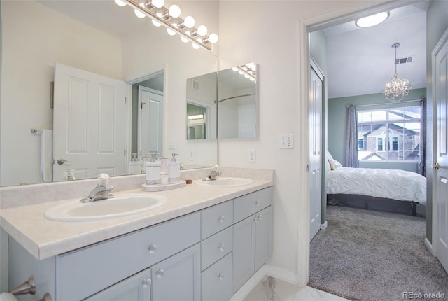 bathroom with vanity and an inviting chandelier