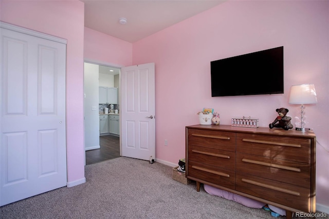 bedroom featuring light carpet and ensuite bath