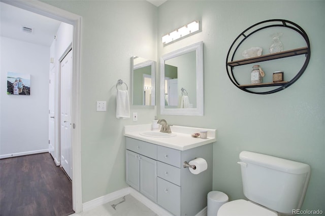 bathroom featuring hardwood / wood-style floors, vanity, and toilet