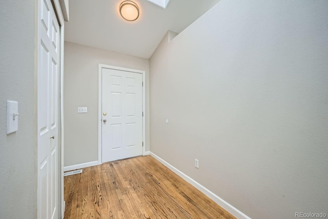 hall with light hardwood / wood-style flooring