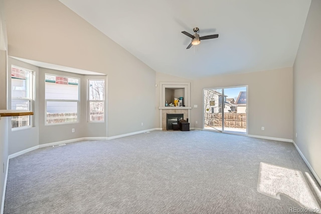 unfurnished living room with lofted ceiling, a fireplace, light colored carpet, and ceiling fan