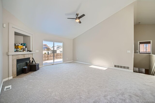 unfurnished living room featuring ceiling fan, high vaulted ceiling, carpet floors, and a tile fireplace