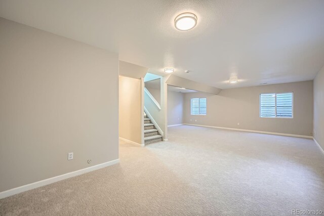 basement with light carpet and a textured ceiling