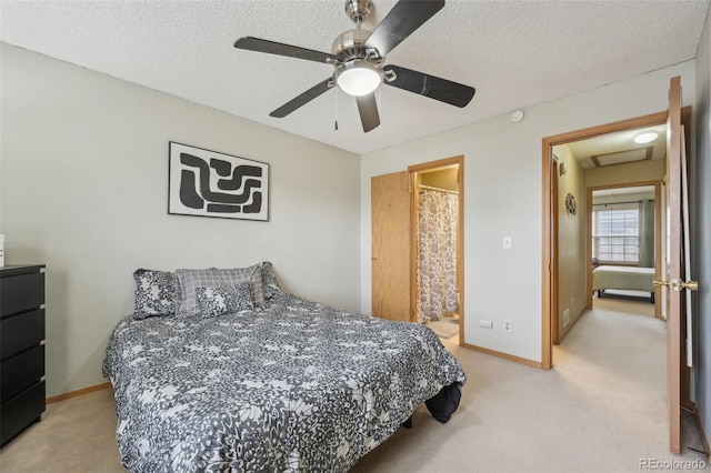 bedroom with carpet floors, attic access, a textured ceiling, and baseboards