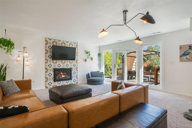 living room featuring carpet flooring and a fireplace