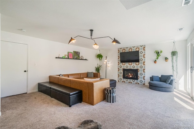 living room featuring a stone fireplace and carpet