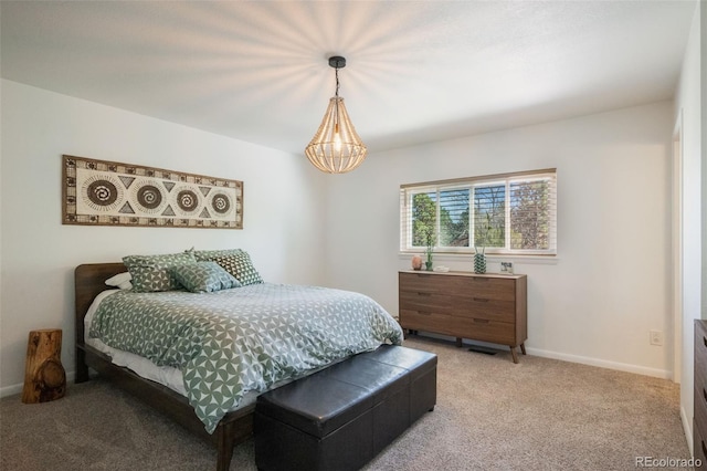 bedroom featuring an inviting chandelier and carpet flooring