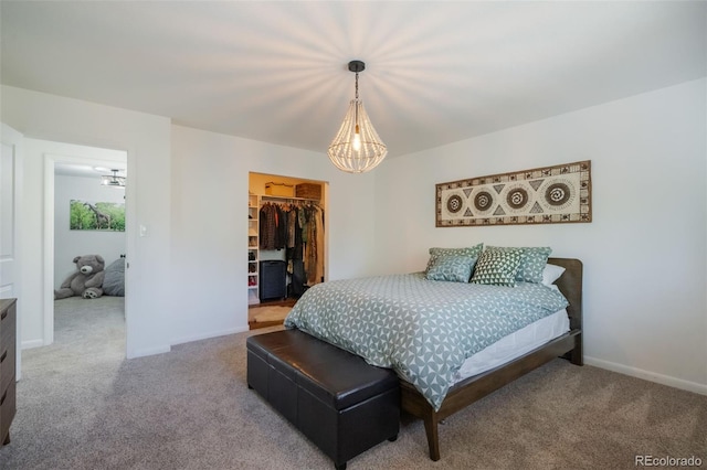 bedroom with a walk in closet, carpet floors, and a closet