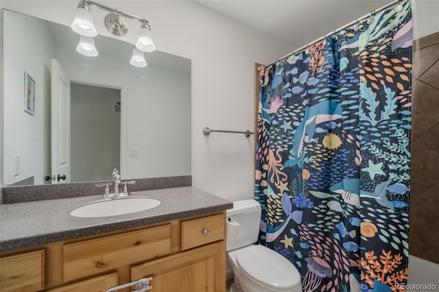 bathroom with vanity, a shower with shower curtain, and toilet