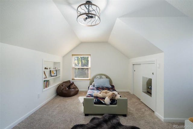 sitting room featuring carpet, lofted ceiling, and built in shelves