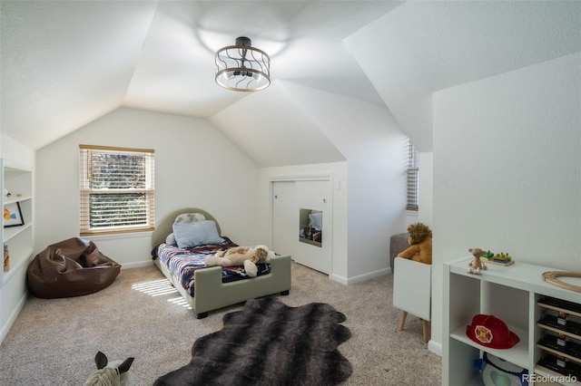 carpeted bedroom with lofted ceiling