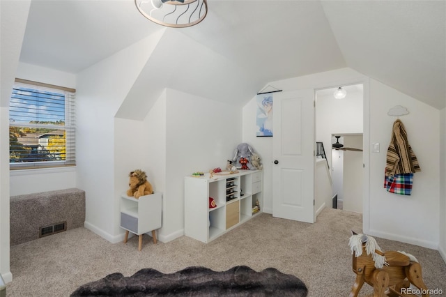 game room featuring lofted ceiling and light colored carpet