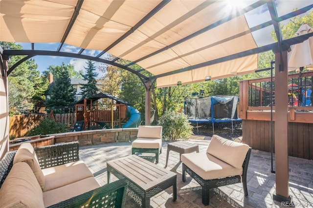 view of patio featuring an outdoor hangout area, a trampoline, and a playground