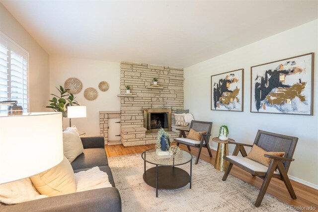2744 S Newton Way, Denver, CO 80236 - living area with wood finished floors, a fireplace, and baseboards