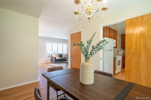2744 S Newton Way, Denver, CO 80236 - dining area featuring a chandelier, light wood-style flooring, and baseboards