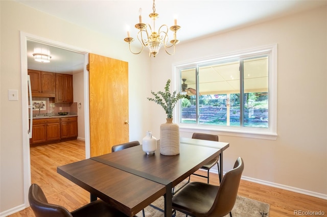 2744 S Newton Way, Denver, CO 80236 - dining space featuring a chandelier, light wood finished floors, and baseboards
