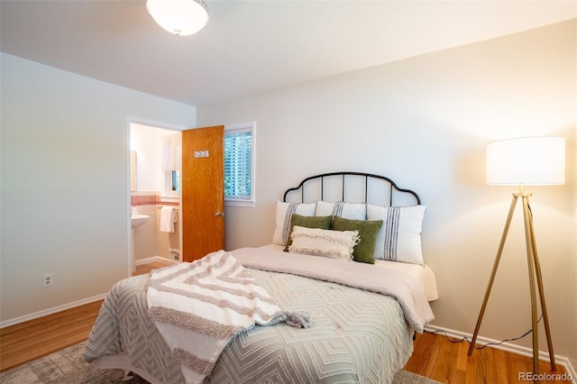 2744 S Newton Way, Denver, CO 80236 - bedroom featuring wood finished floors, baseboards, and ensuite bath