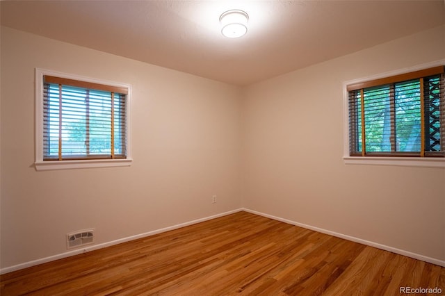 2744 S Newton Way, Denver, CO 80236 - spare room featuring baseboards and wood finished floors