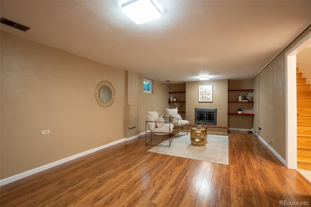 2744 S Newton Way, Denver, CO 80236 - living area featuring wood finished floors, stairway, baseboards, and a glass covered fireplace