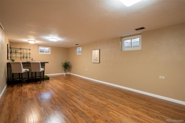 2744 S Newton Way, Denver, CO 80236 - below grade area featuring wet bar, wood finished floors, and baseboards