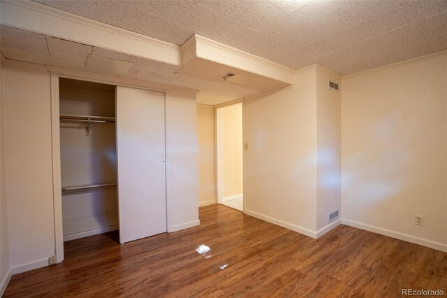 2744 S Newton Way, Denver, CO 80236 - unfurnished bedroom featuring wood finished floors, baseboards, a closet, and ornamental molding
