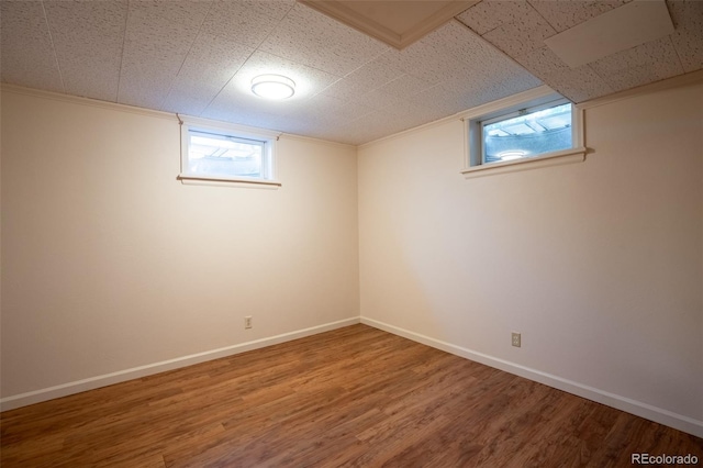 2744 S Newton Way, Denver, CO 80236 - below grade area featuring wood finished floors, healthy amount of natural light, baseboards, and crown molding