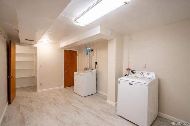2744 S Newton Way, Denver, CO 80236 - laundry area with washer and clothes dryer and baseboards